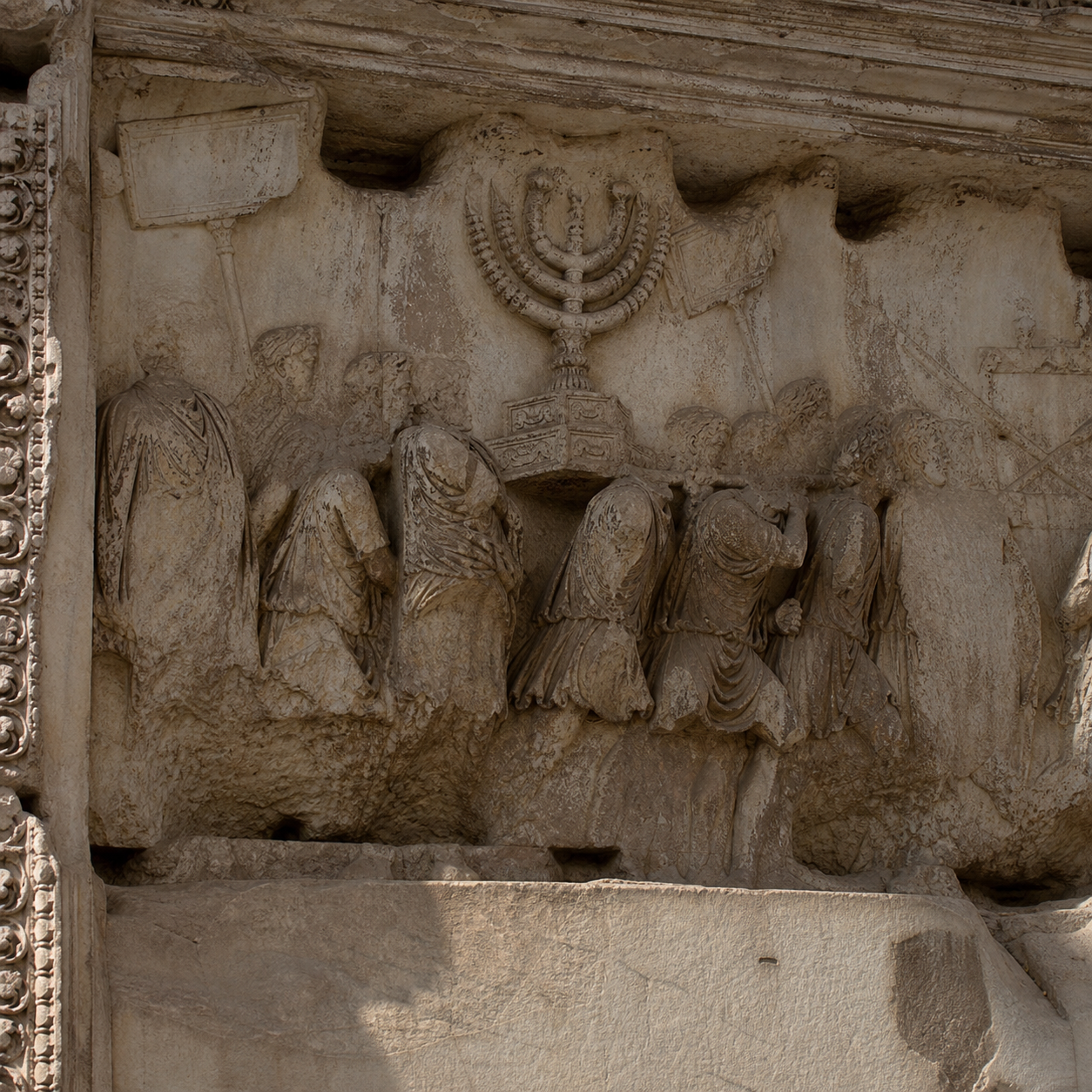 Editorial reconstruction of the Arch of Titus relief showing Roman figures carrying the seven-branched Temple menorah